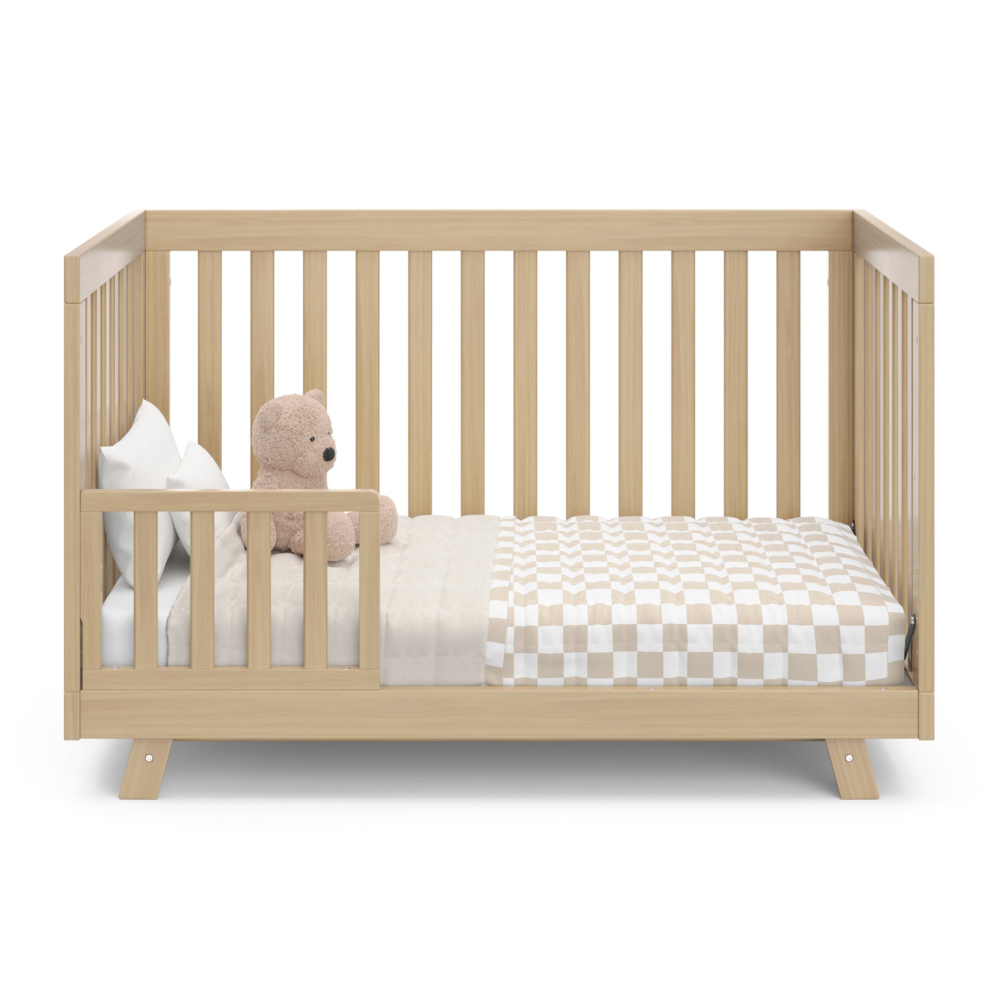Front view of Driftwood Crib in toddler conversion with one guardrail