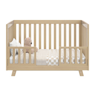 Front view of Driftwood Crib in toddler conversion with two guardrails