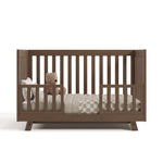 Beckett hazelnut crib converted to toddler bed with two guardrails