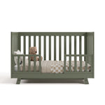 Beckett olive crib converted to toddler bed with two guardrails