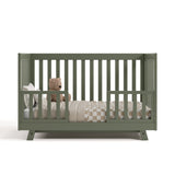 Beckett olive crib converted to toddler bed with two guardrails