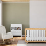 Beckett natural with white crib in nursery next to rocker and changing dresser