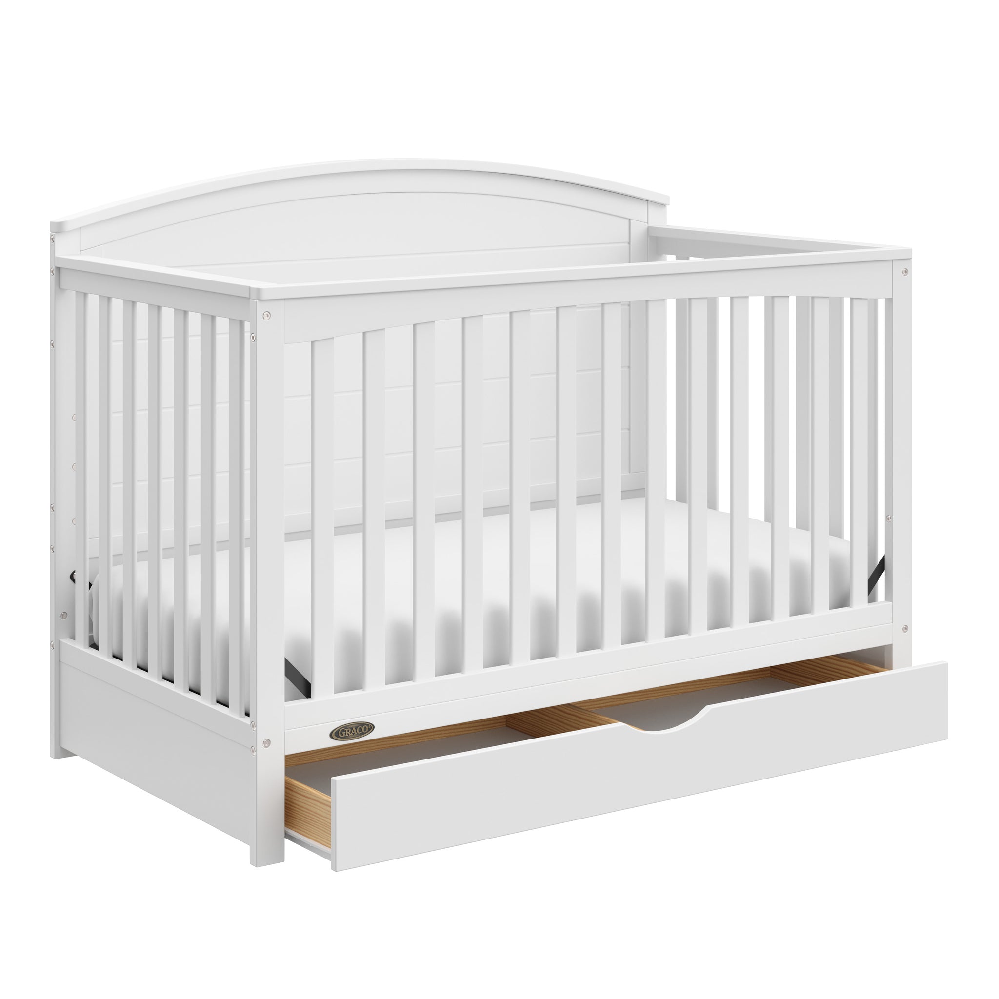 Convertible white crib with an open drawer, viewed from an angle
