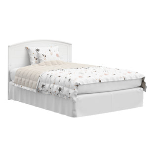 Convertible white crib transformed into a bed with headboard only