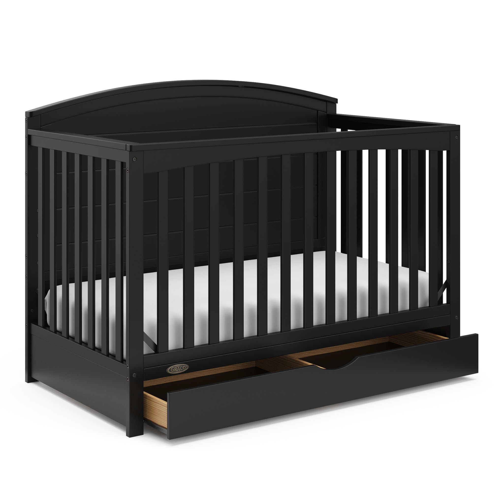Convertible black crib with an open drawer, viewed from an angle