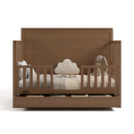 Sasha hazelnut crib with drawer open converted to toddler bed with two guardrails