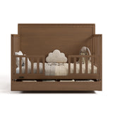 Sasha hazelnut crib with drawer open converted to toddler bed with two guardrails