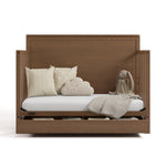 Sasha hazelnut crib with drawer open converted to daybed