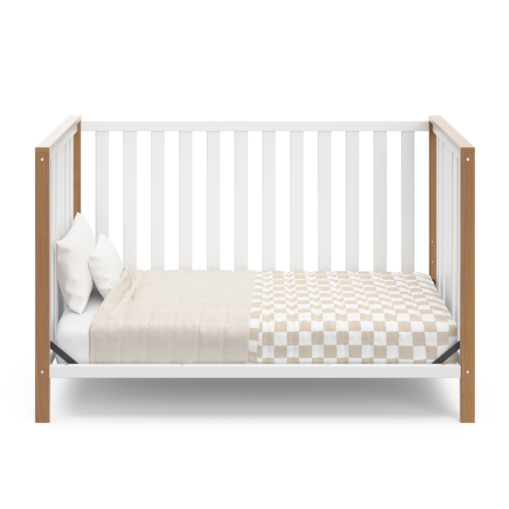 White crib with driftwood in toddler bed conversion