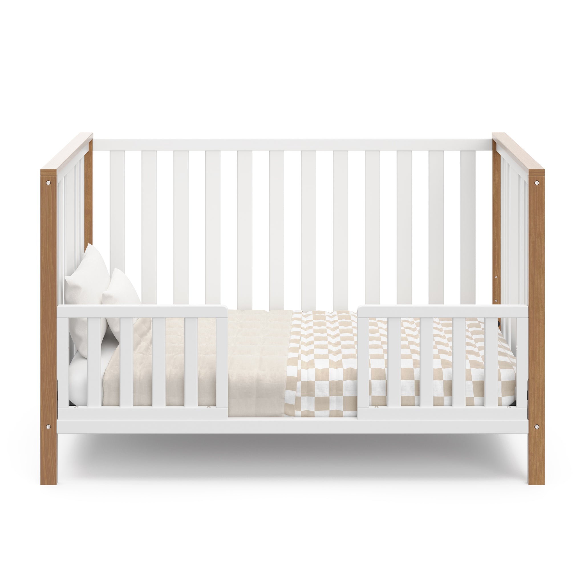 White crib with driftwood in toddler bed conversion with two safety guardrails
