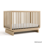Santorini driftwood crib with 2024 Storkcraft copyright on bottom right