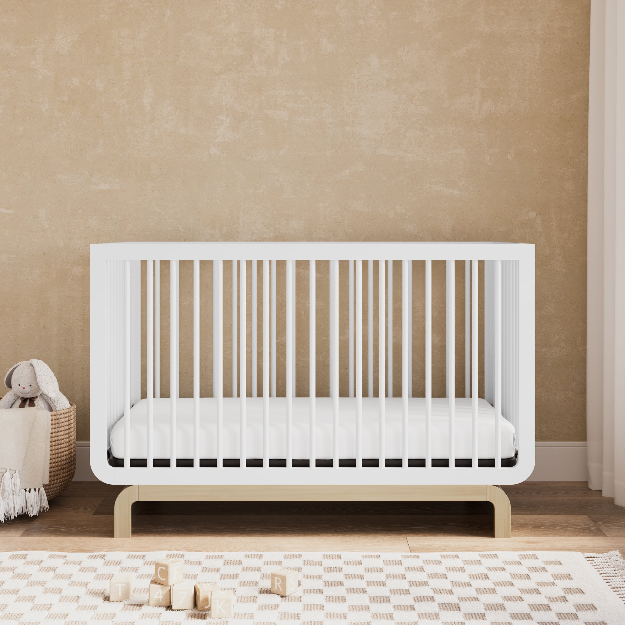 Convertible crib in white with driftwood colorway in a nursery