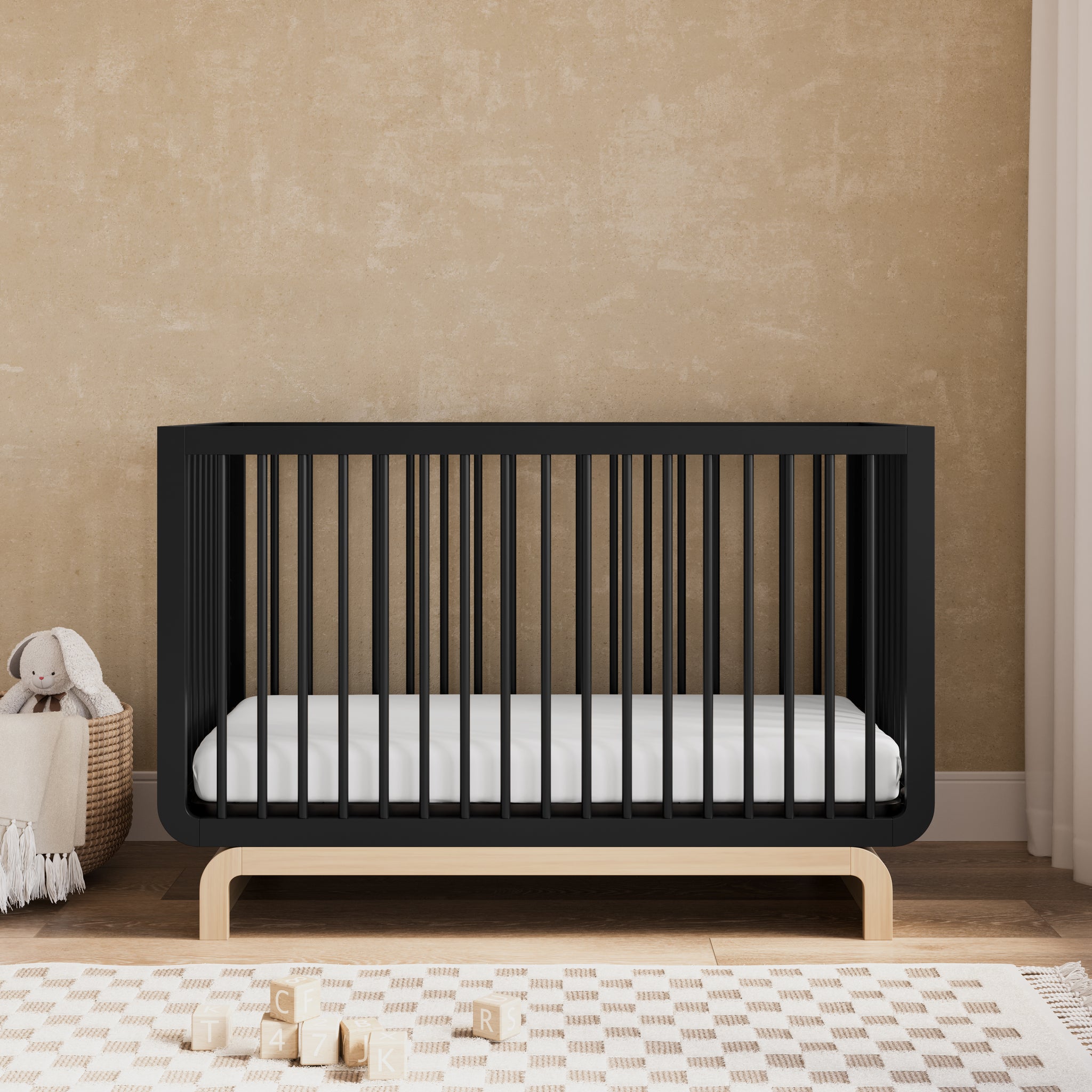 Convertible crib in black with driftwood colorway in a nursery