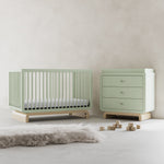 Santorini sage with driftwood 3 drawer chest with changing topper in a nursery next to crib