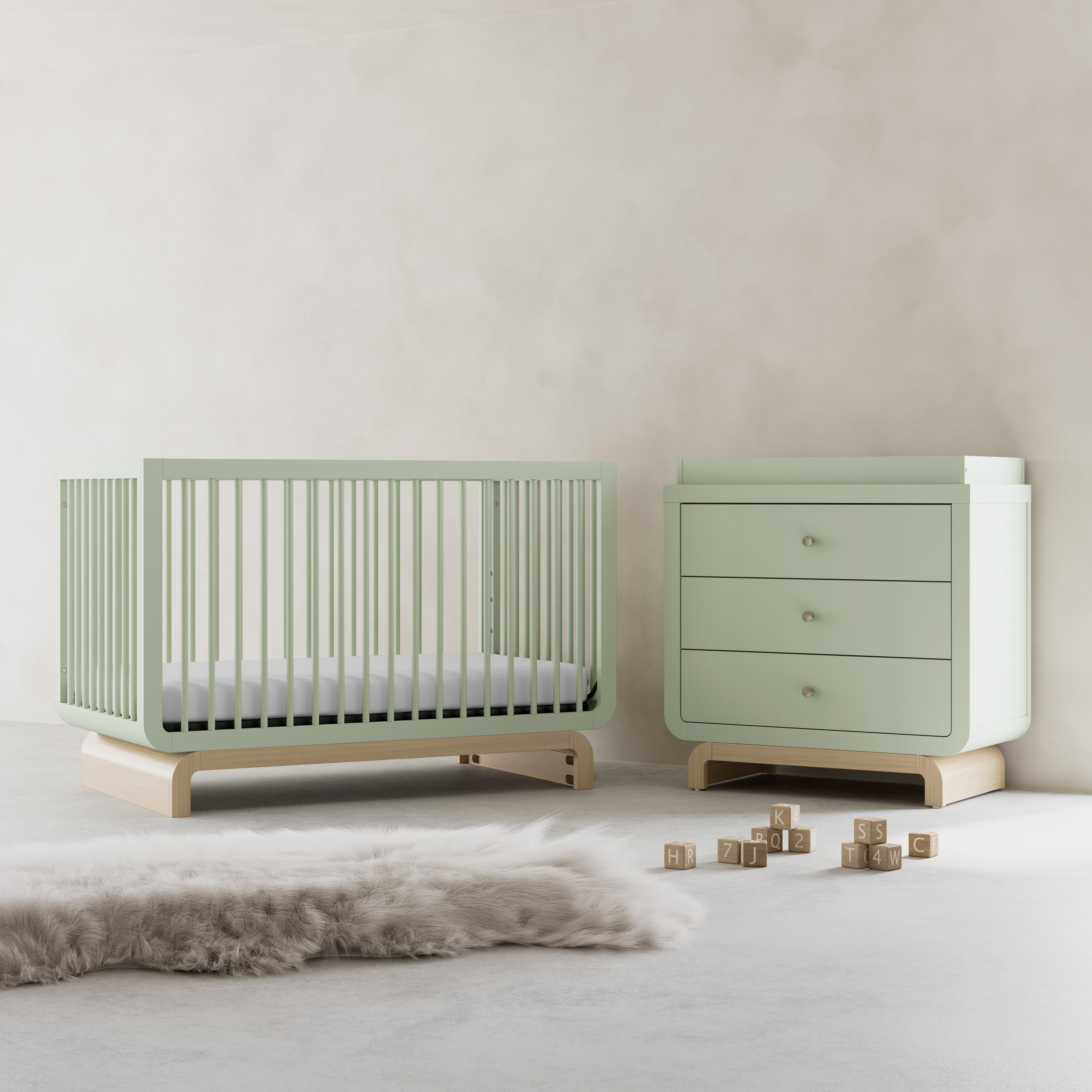 Santorini sage with driftwood 3 drawer chest with changing topper in a nursery next to crib