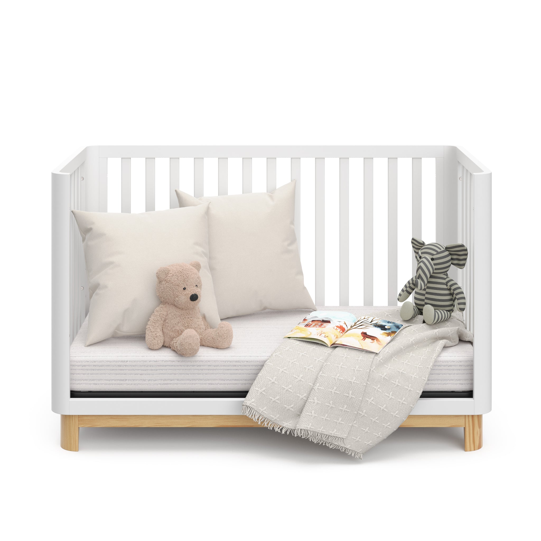 Front view of a white crib with a natural wood color base in daybed conversion