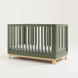 Angled view of an olive crib with a natural wood color base