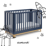 santos midnight blue with natural crib with black cartoon drawings