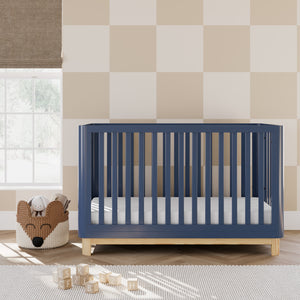 Midnight blue crib with a natural wood color base in nursery