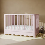 Casablanca blush crib with drawer in a nursery