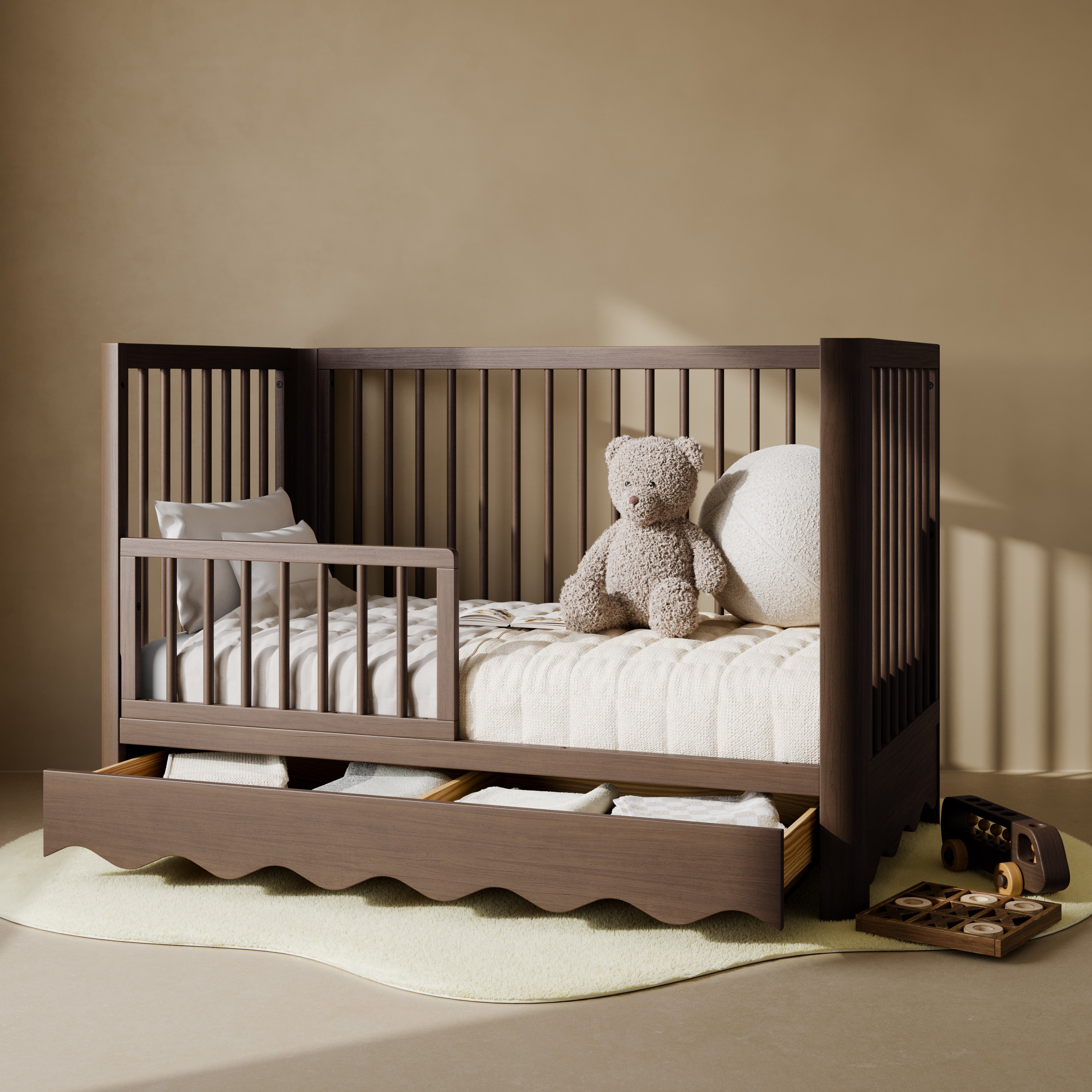 Casablanca hazelnut crib with drawer converted to toddler bed with guardrail attached in nursery