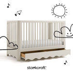 Casablanca frosted oat crib angle view with drawer open and black cartoon drawings overlaid on image