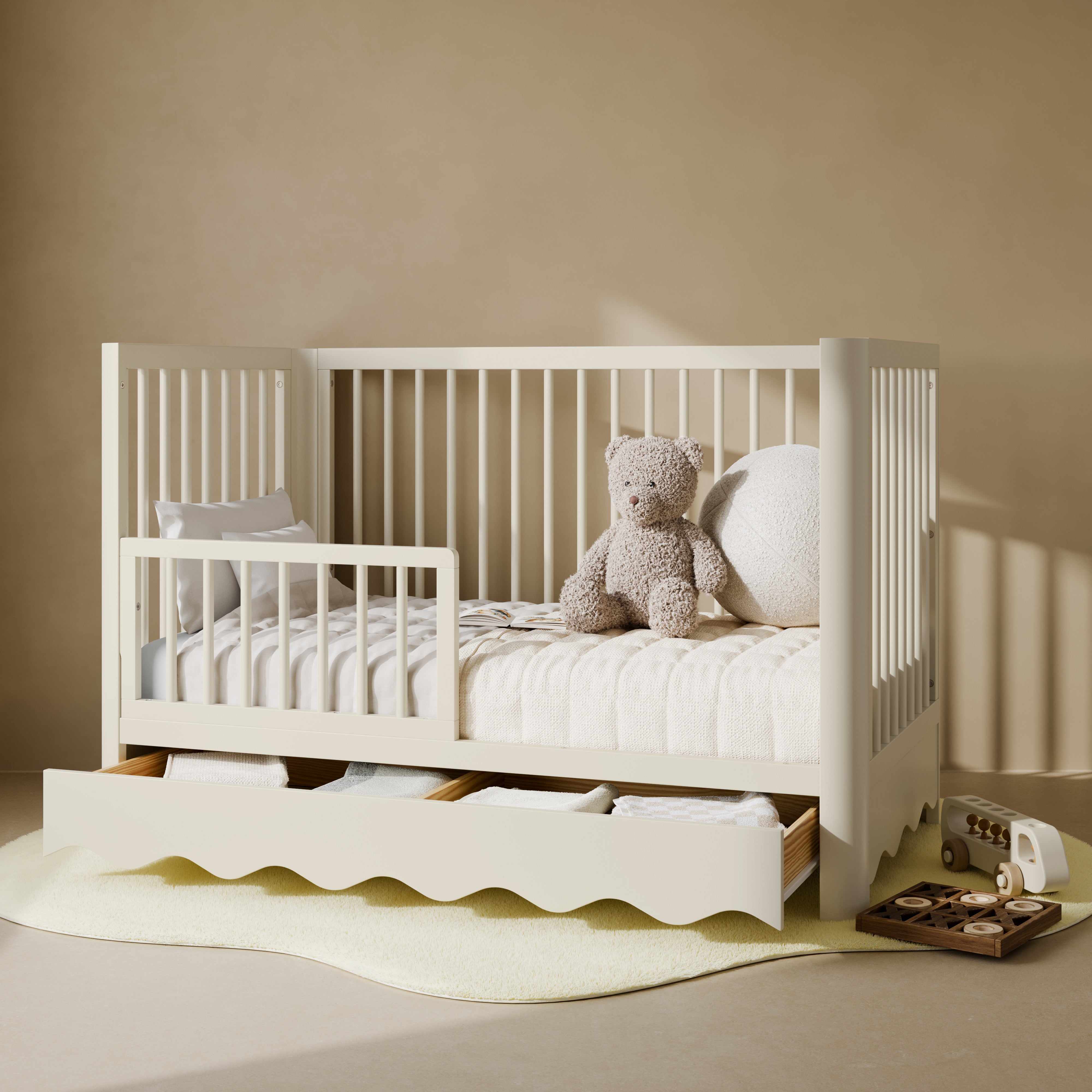 Casablanca frosted oat crib with drawer converted to toddler bed with guardrail attached in nursery