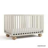 Amalfi frosted oat crib with 2025 Storkcraft copyright on bottom right