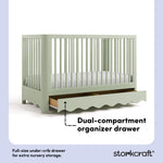 Casablanca sage crib angle view with drawer open showing dual-compartment storage drawer callout image