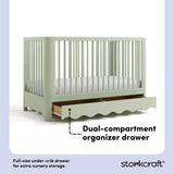 Casablanca sage crib angle view with drawer open showing dual-compartment storage drawer callout image
