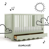 Casablanca sage crib angle view with drawer open and black cartoon drawings overlaid on image