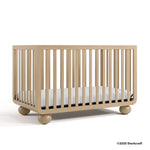 Amalfi driftwood crib with 2025 Storkcraft copyright on bottom right