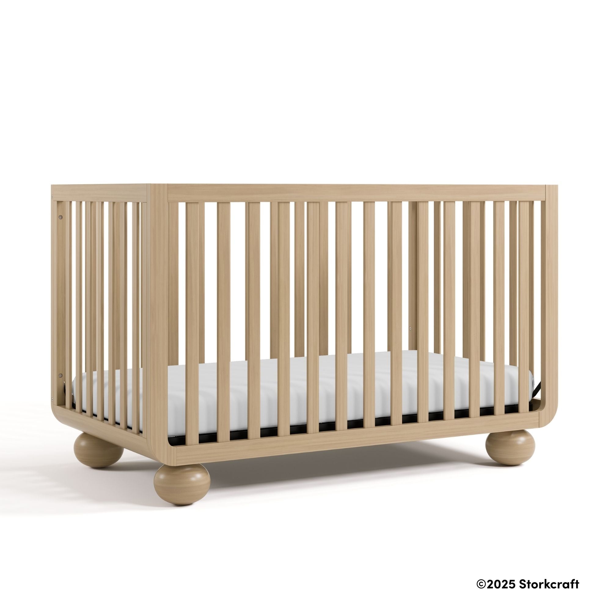 Amalfi driftwood crib with 2025 Storkcraft copyright on bottom right