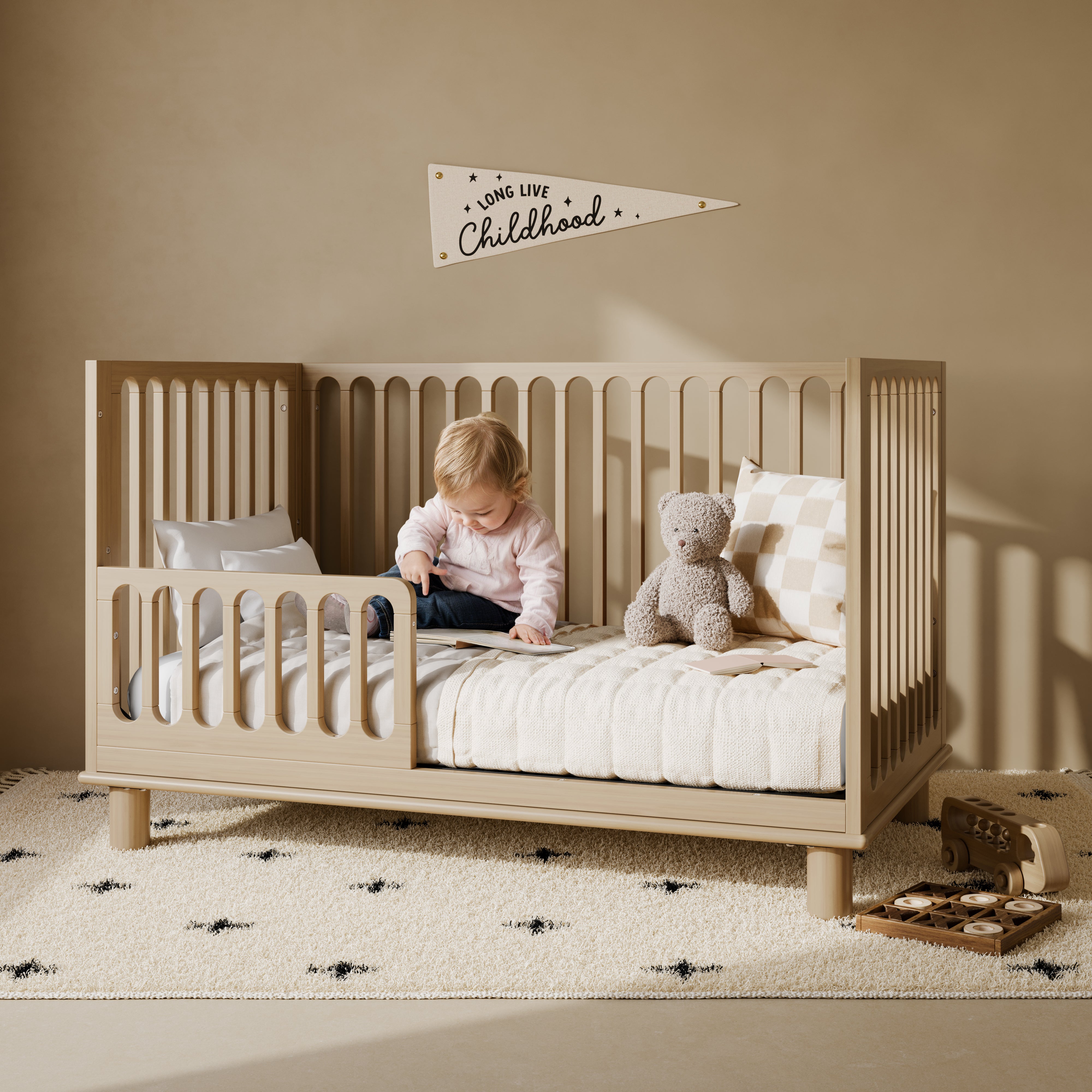 Sicily driftwood crib converted to toddler bed in a nursery