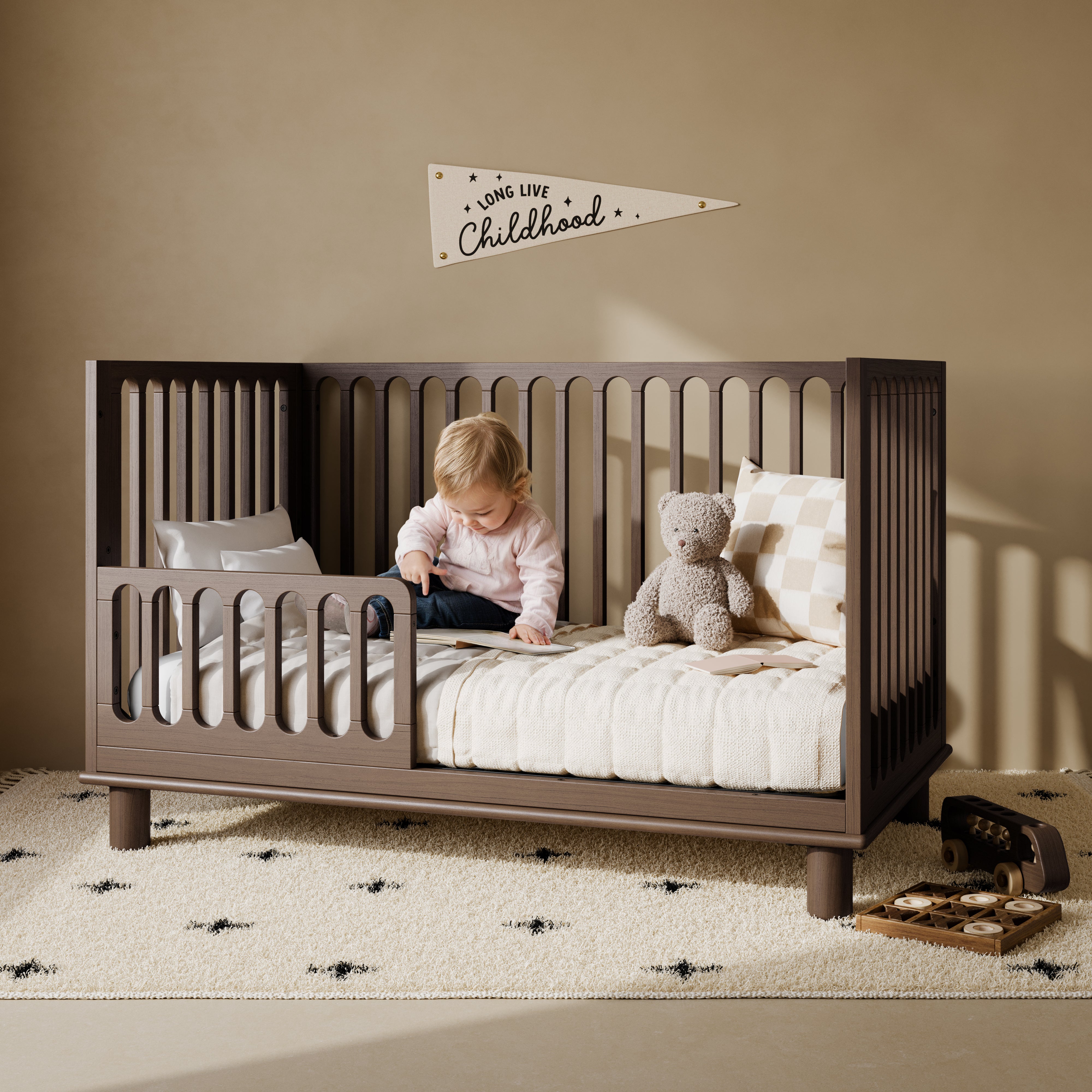 Sicily hazelnut crib converted to toddler bed in a nursery