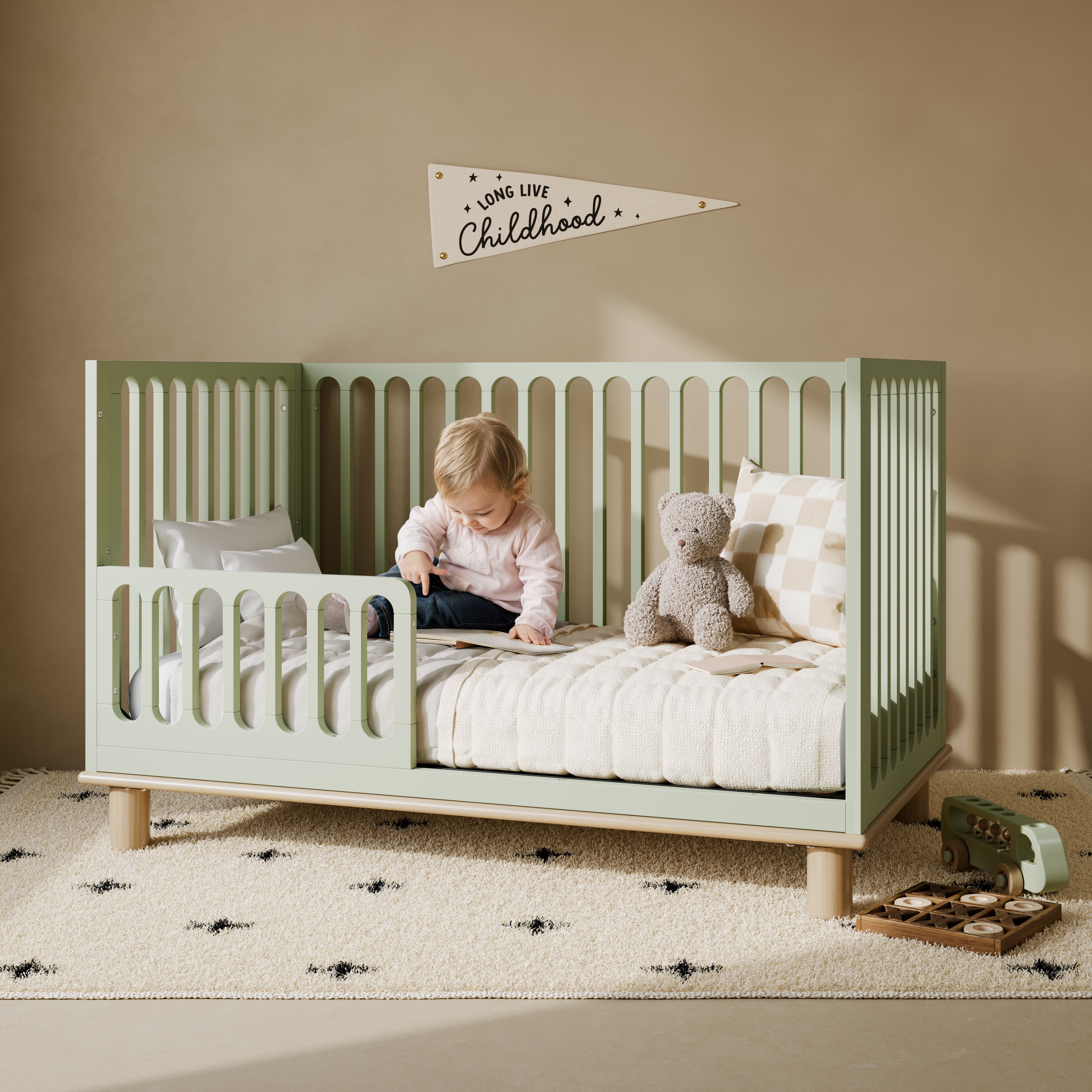 Sicily sage with driftwood crib converted to toddler bed in a nursery