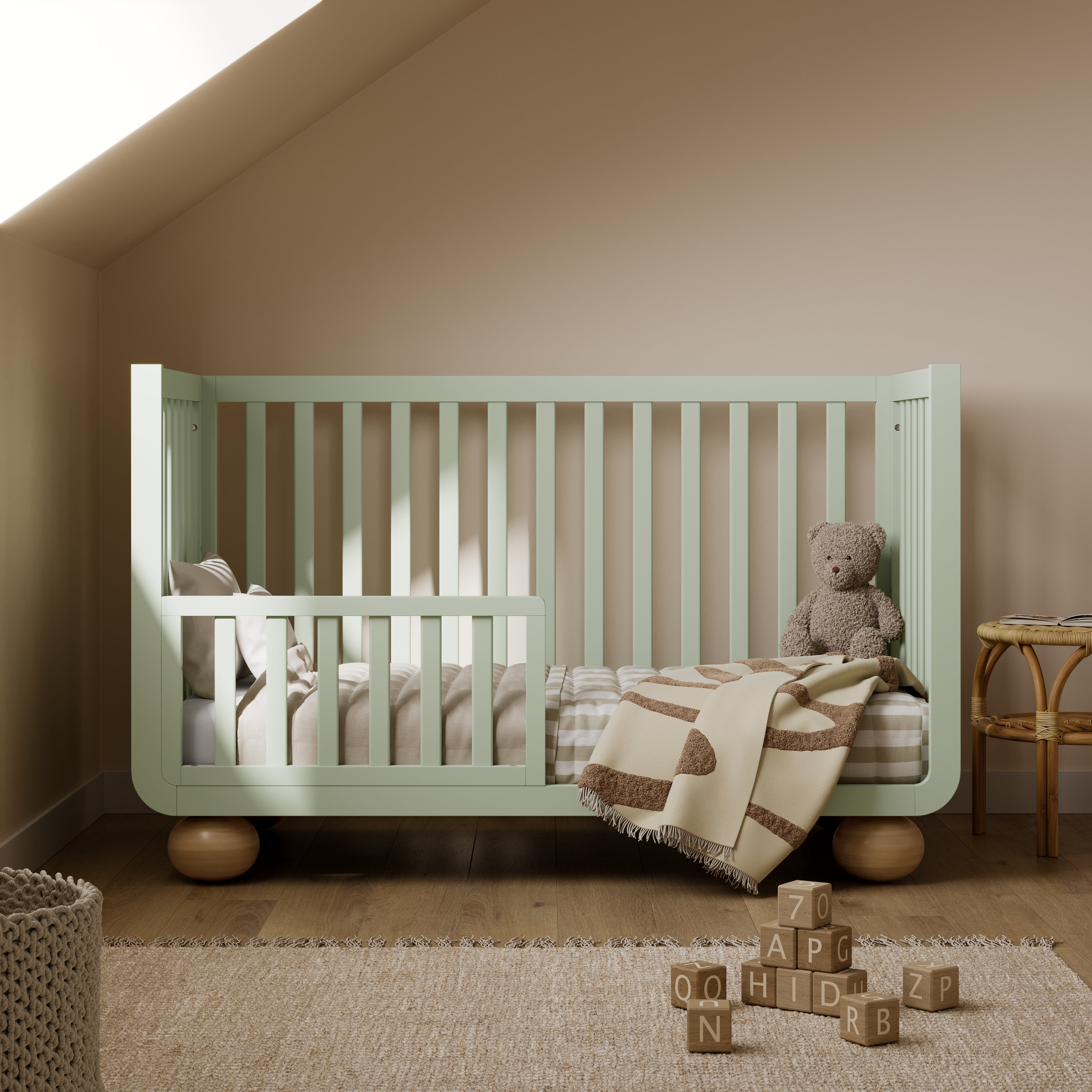Amalfi sage with driftwood crib converted to toddler bed in nursery