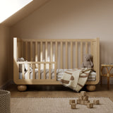 Amalfi driftwood crib converted to toddler bed in nursery