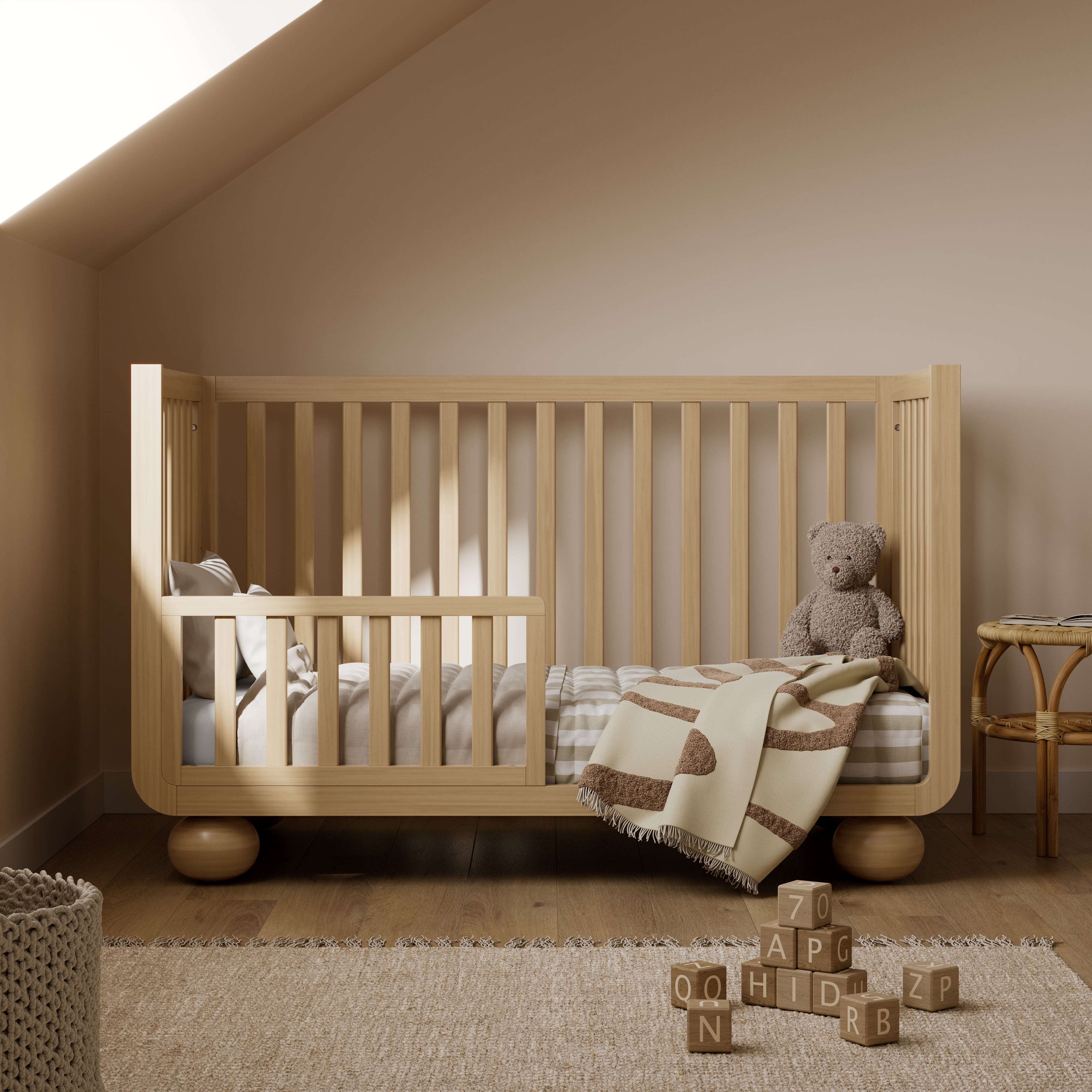 Amalfi driftwood crib converted to toddler bed in nursery