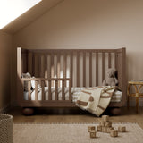 Amalfi hazelnut crib converted to toddler bed in nursery