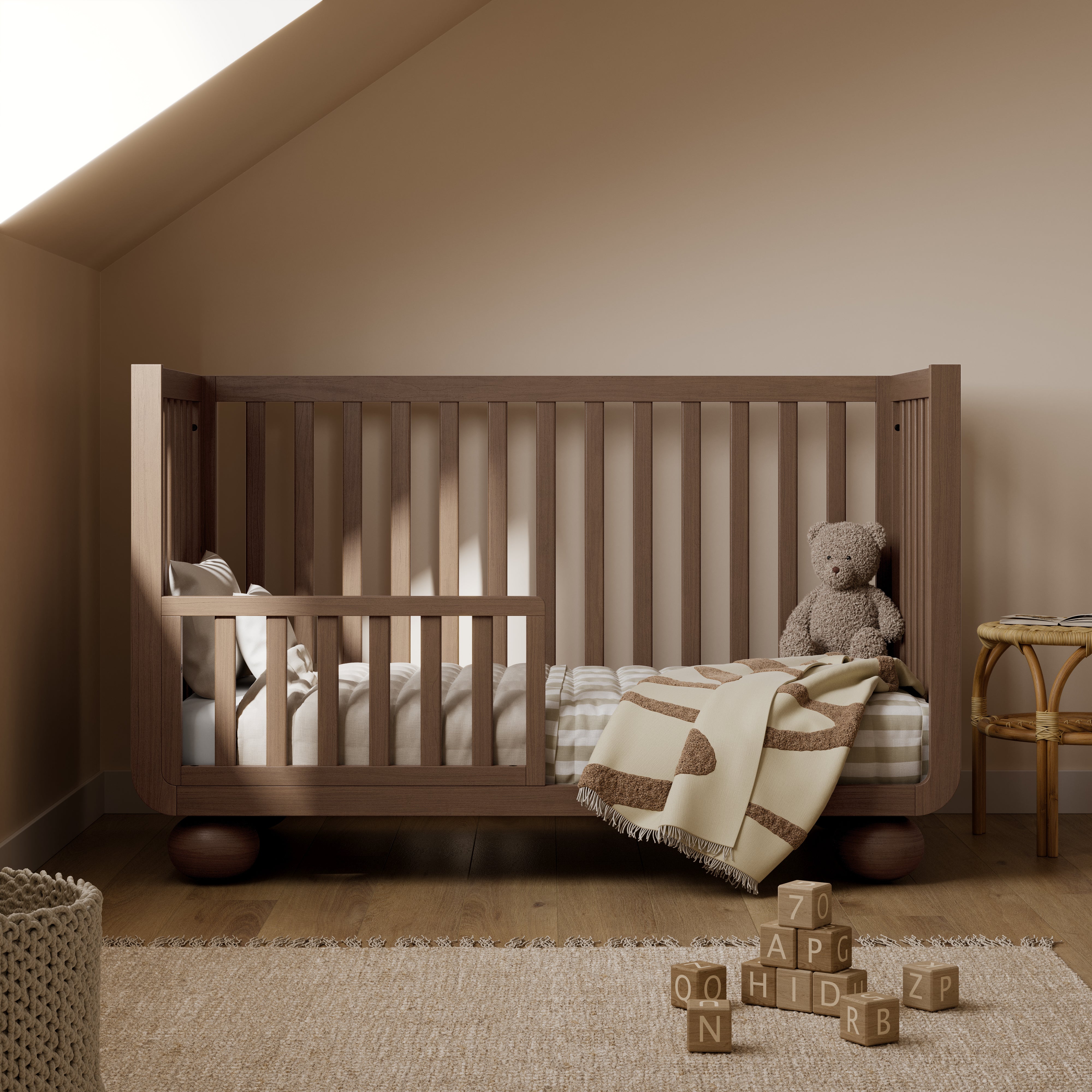 Amalfi hazelnut crib converted to toddler bed in nursery