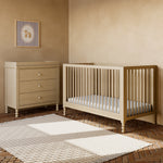 Rio driftwood crib next to 3 drawer dresser in a nursery