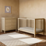 Rio driftwood crib next to 3 drawer dresser in a nursery