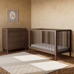 Rio hazelnut crib next to 3 drawer dresser in a nursery
