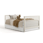 Rio frosted oat crib converted to full-size bed with footboard