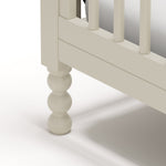Rio frosted oat crib close up of solid wood turning feet