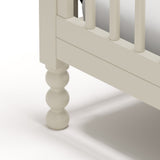 Rio frosted oat crib close up of solid wood turning feet