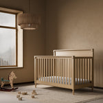 Storkcraft Valencia 5-in-1 Convertible Crib in Driftwood Lifestyle Image in a nursery 