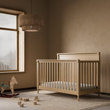 Storkcraft Valencia 5-in-1 Convertible Crib in Driftwood Lifestyle Image in a nursery 