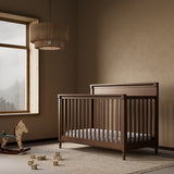 Storkcraft Valencia 5-in-1 Convertible Crib in Hazelnut Lifestyle Image in a nursery 